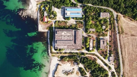 Abandoned Seaside Industrial Complex Bright Sunny Day Coast Blue Water Top Down Stock Footage 235657624