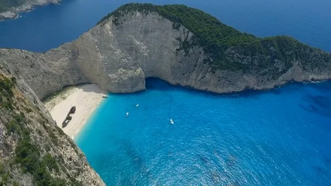 Abandoned ship on white sandy coast in mediterranean sea Video stock 98737622