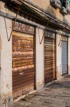 Abandoned shops with rusty roller blinds Stock Photos