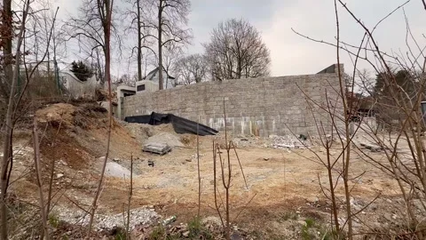 An Abandoned Site featuring a Ruined Wall and Preparation of the Ground for Stock Footage 304804861