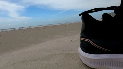 Abandoned Sneakers on the Shore Stock Footage 301732537