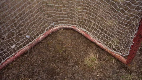 Abandoned soccer corner scene, old soccer goal with weathered net and rusty post Stock Footage 326203092