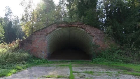 Abandoned soviet nuclear missile base. Concrete bunker entrance in a forest Vídeos de archivo 347016929