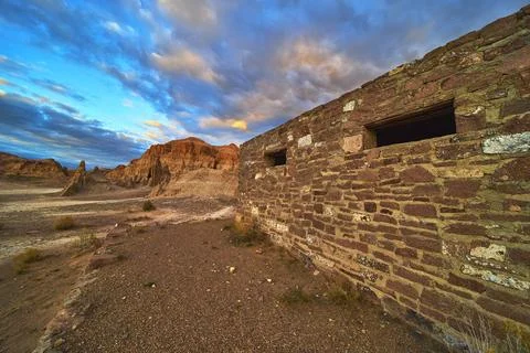 Abandoned Stone Building and Dramatic Cliffs at Cathedral Gorge State Park .. Stock Photos