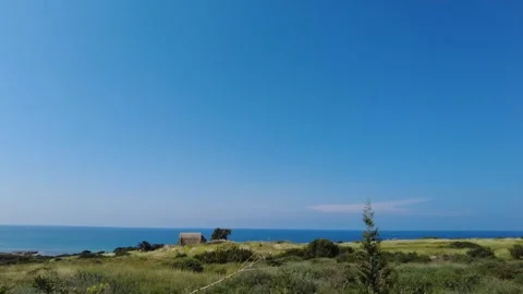 An abandoned stone building, road with greenery and sea views. Stock Footage 278107053