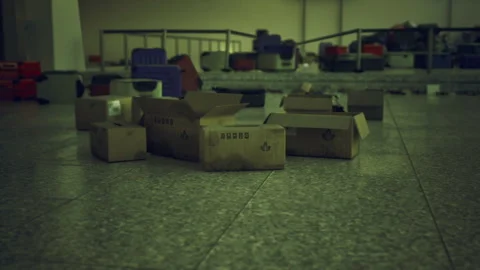 Abandoned storage space featuring scattered boxes and dim lighting Stock Footage 329943649