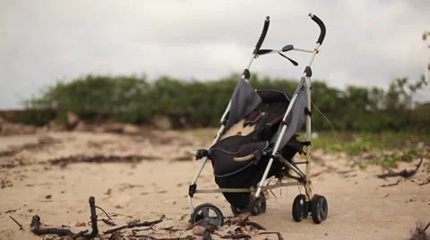 Abandoned Stroller on a Beach Stock Footage 33193322