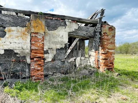 Abandoned structure features crumbling brick walls and exposed beams Stock Photos