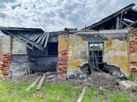 Abandoned structure features crumbling brick walls and exposed beams Stock Photos