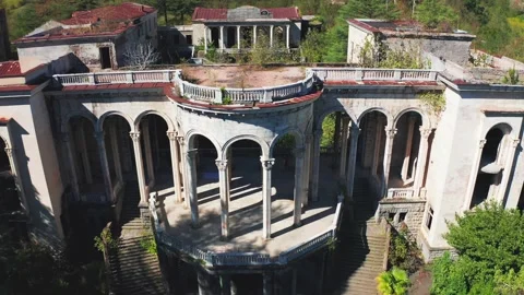 Abandoned structure featuring crumbling arches, overgrown hallways, and haunting Stock Footage 297318112