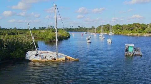 Abandoned sunken sailboat creating marine pollution in Anclote River, Holiday Stock Footage 333453077