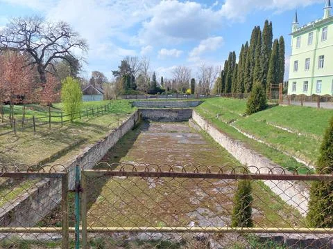Abandoned swimming pool built inside the former defensive moat of a castle Stock Photos