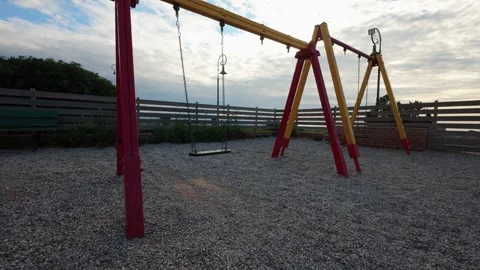 Abandoned Swing Moving Alone in Empty Playground Stock Footage 303399528