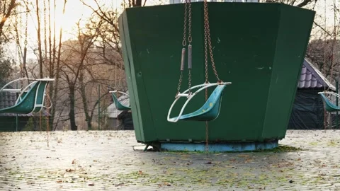 Abandoned Swing Ride in an Empty Park During Autumn Stock Footage 326036379