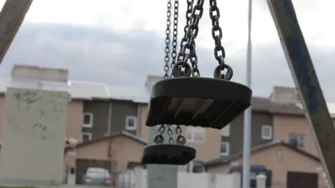 Abandoned swing set on children playground in a city yard Stock Footage 233464226