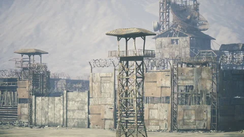 Abandoned trading station featuring tall watchtower and stacked debris walls Stock Footage 335596205