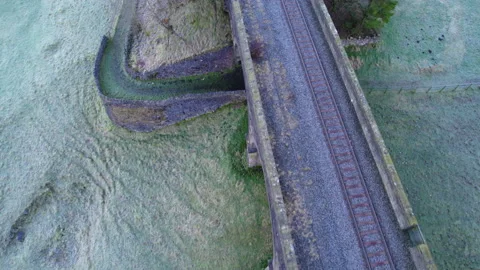 Abandoned train tracks over an icey hill in the early hours of the morning Stock Footage 230155289