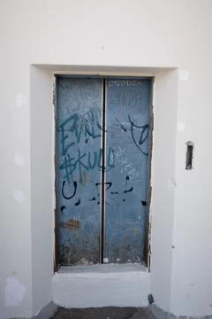 Abandoned, vandalized elevator door covered with graffiti in Tlaquepaque, Mexico Stock Photos