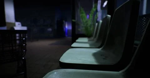 Abandoned waiting area with empty chairs in dimly lit interior space Stock Illustration
