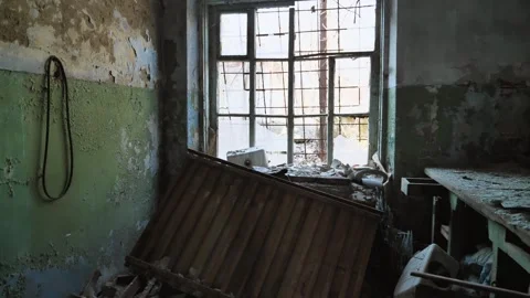 An abandoned warehouse with broken windows and a desk Stock Footage 270127746