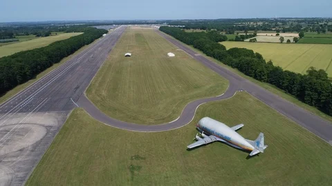 Abandoned wide bodied cargo aeroplane at disused airport, drone aerial 4K Stock Footage 101178276