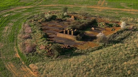 Abandoned World War II bunker ruins surrounded by farmland and dirt tracks Vídeo Stock 339343387