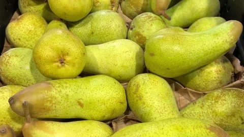 Abate Fetel pears arranged in box on greengrocer's shelf Stock Footage 307792767
