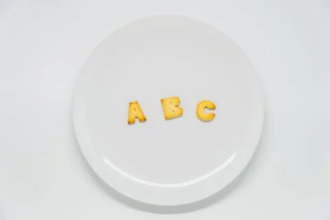 ABC alphabet cracker on dish with white background Stock Photos