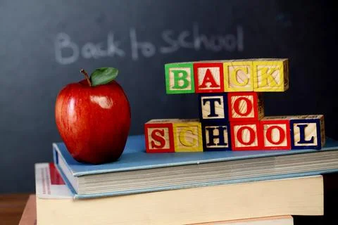 ABC blocks and apple against black board Stock Photos