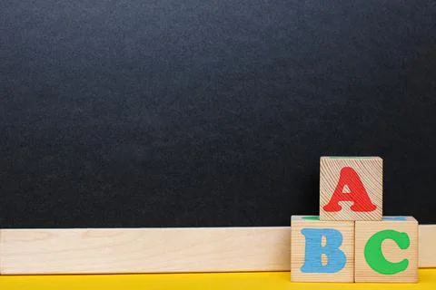 ABC blocks next to a blackboard. Back to school. English for beginners. Foto stock
