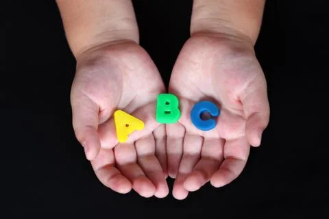 Abc in child hands Stock Photos