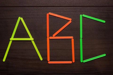 Abc formed with counting sticks over wooden background Stock Photos