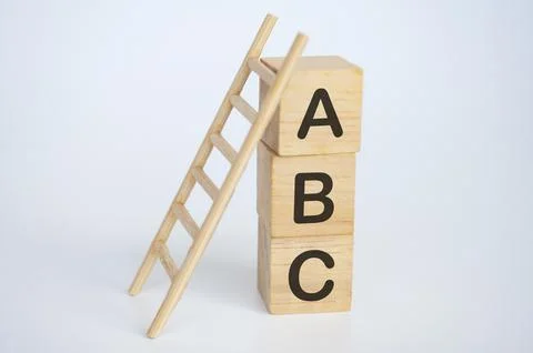 ABC text on wooden cubes with ladder on white background. Learning concept Fotos Stock