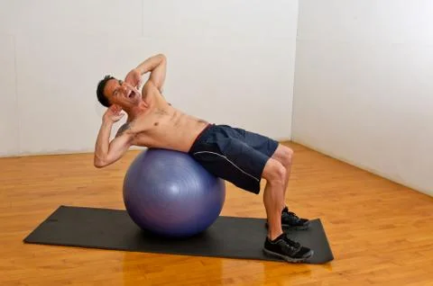 Abdominal crunches on stability ball Stock Photos