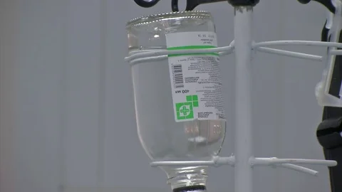 Abdominal liposuction. Selective focus Infusion bottle with IV solution in the Stock Footage 83190396