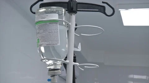 Abdominal liposuction. Selective focus Infusion bottle with IV solution in the Video stock 83200771