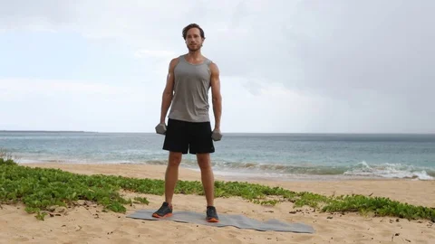 Abdominal workout exercise - Dumbbell Side Bend by fitness man on beach Video stock 79847697
