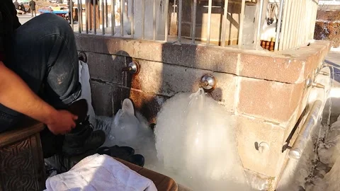 Ablution at Ancient Water Source | Muslim Man Wudu in Freezing Water Stock Footage 303277383