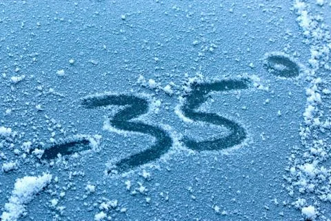 Abnormal cold snap and winter cold. The inscription on ice or frozen glass is Fotos Stock