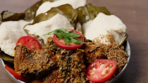 Abolo Soft Steamed Corn Cakes, Amatadzi Green Leaf Stew, Agushi, Tuna Fish Video stock 346250088