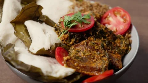Abolo Soft Steamed Corn Cakes, Amatadzi Green Leaf Stew, Agushi, Tuna Fish Video stock 346250128