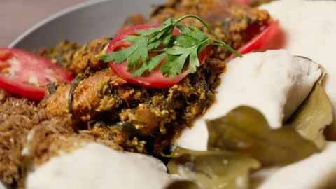 Abolo, Soft Steamed Corn Cakes With Amatadzi Spicy Green Leaf Stew, Agushi Video stock 346250177