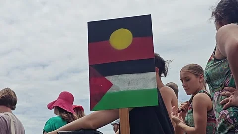 ABORIGINAL AND PALESTINIAN FLAG SIDE BY SIDE DURING INVASION DAY AUSTRALIA 4K Stock Footage 262713606