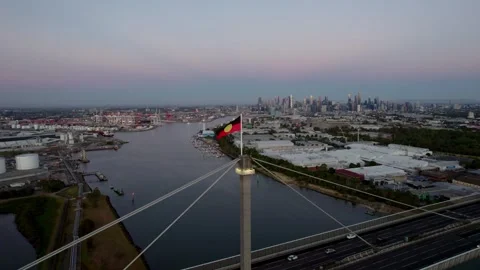Aboriginal flag flying on top of Westgate bridge, sunset Stock Footage 329161365
