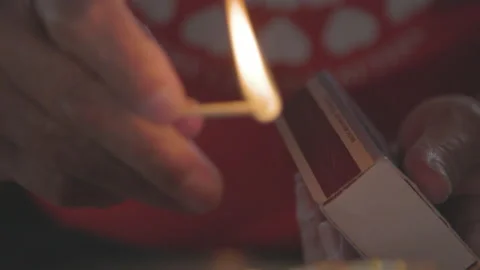 Aboriginal man lighting match for smudging ceremony Stock-Footage 164395034