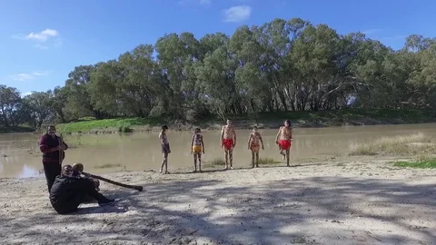 Aboriginal young kids dancing on the side of the river in Australia Stock Footage 72225881