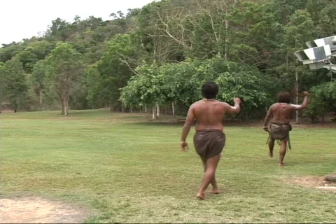 Aborigine throws boomerang Stock Footage