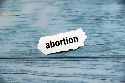 Abortion Text or message short word english letter on white paper with blue.. Stock Photos