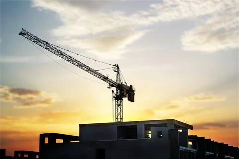 About the tower crane at a building when silhouette Stock Photos