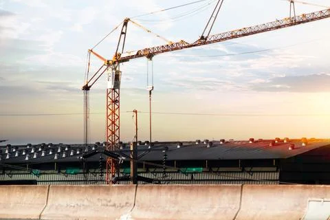 About the tower crane at a building when silhouette Stock Photos